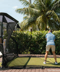 Person practicing golf with Mevo Launch Monitor Bundle With Pro Series Golf Net And Side Barriers for outdoor use