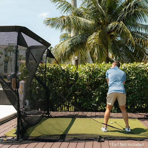 Person practicing golf with Mevo Launch Monitor Bundle With Pro Series Golf Net And Side Barriers for outdoor use