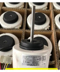Close-up of a 310V DC Brushless Fan Motor For Air Conditioners WZDK58-38G 8-Pole 58W Replacement Part, shaft and label visible