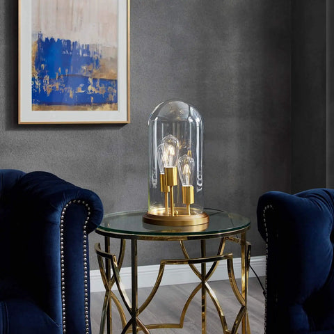 Vintage Brass Glass Cloche End Table Lamp With Industrial Modern Vibe on round glass table between blue armchairs
