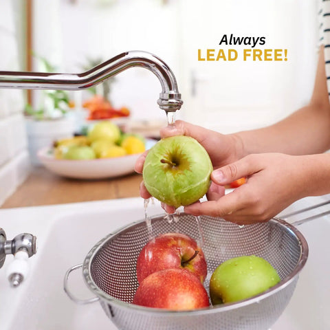 Person washing apples under a lead-free faucet in a kitchen sink