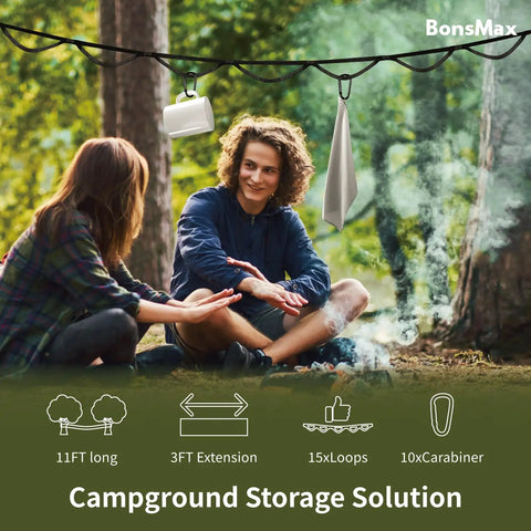 Camping Gear Storage Strap Organizer With Cam Buckles And 15 Loops 10 Aluminum Carabiners For Hanging Tents And Gear In RVs Backyards Or Garages Heavy Duty 500 Lb Load 11 Feet Black hanging in campsite with people.
