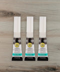 No Drip Instant Jewelry Glue Waterproof Adhesive Mess Free For Repairing Necklaces, Bracelets, And Earrings, Strong Bond For Quick Fixes, Clear Cure, 3 Pack For All Jewelry Repairs, shown in three tubes on a wooden background.