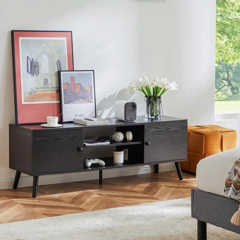 Mid Century Modern TV Stand For 55 To 60 Inch TVs With Storage, wooden black finish, two cabinets with soft close doors in a living room.