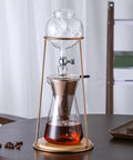 Kickback Cold Brew Dripper Coffee Tower Featuring Adjustable Stainless Steel Drip Valve For Rich Smooth Low Acid Iced Coffee Brewing At Home Or Outside Whenever You Wanna, with ice and brewed coffee.