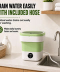 Road Ready Foldable Mini Washing Machine in matte green with drainage hose, portable design for easy water disposal.