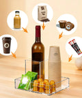 Clear Acrylic Coffee Cup Holder For Countertop With Three Compartments For Cups Lids Straws Pods Sugar Packets And Tea Bags A Handy Coffee Bar Organizer For Kitchen Counters featuring wine bottle, sugar, and pods.