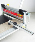 Beast Of A 13 Inch Laminate Flooring And Siding Cutter with clamp and sliding extension table shown cutting wood board