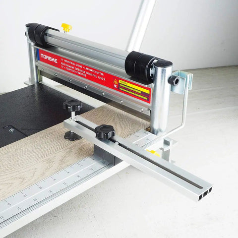 Beast Of A 13 Inch Laminate Flooring And Siding Cutter with clamp and sliding extension table shown cutting wood board