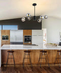 Six Light Black Glass Globe Sputnik Chandelier For Dining Room And Living Room installed over modern kitchen island