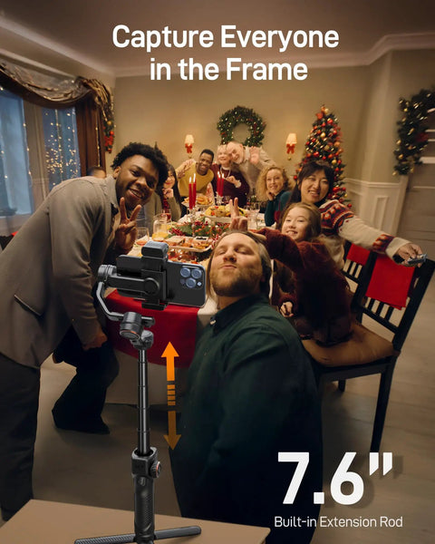 Group holiday dinner with Phone Gimbal Stabilizer With AI Tracking And Detachable One Point Four Inch Touchscreen Remote shown on table.