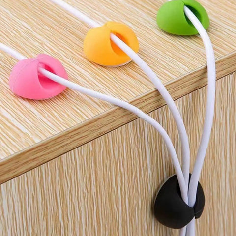 Colorful cable organizer clips maintaining wires on desk edge, illustrating 6 Pack Desk Cable Organizer Clips For Wire Management Adhesive Cord Holders Keep USB Charging Cables Neat And Accessible Office Desktop Organization For Home School And Work