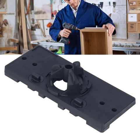 Close-up of a black plastic 35mm hinge jig drilling guide plate for woodworking.