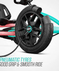 Close-up of wheel with pneumatic tyre on pedal go kart for kids and adults with adjustable seat and BFR system in outdoor use.