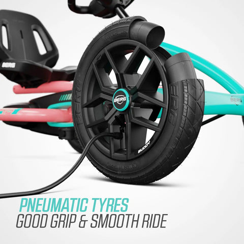 Close-up of wheel with pneumatic tyre on pedal go kart for kids and adults with adjustable seat and BFR system in outdoor use.