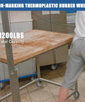 Rock Solid Workhorse 4 Inch Stainless Steel Casters Jam Packed With Thermoplastic Rubber Wheels For Heavy Duty Labor In Labs Or Shops Handles Up To 1200 Lbs in use with a wooden table.