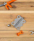 24 Piece Vintage Butterfly Hinges With Replacement Screws For DIY Furniture Projects Sturdy Iron Hardware with tools on wood surface