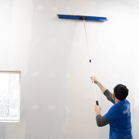 Person using ProSkim Handle Bracket Clamp On For Drywall Finishing Tool With All Angle Adjustment Fits ProSkim Blade on wall