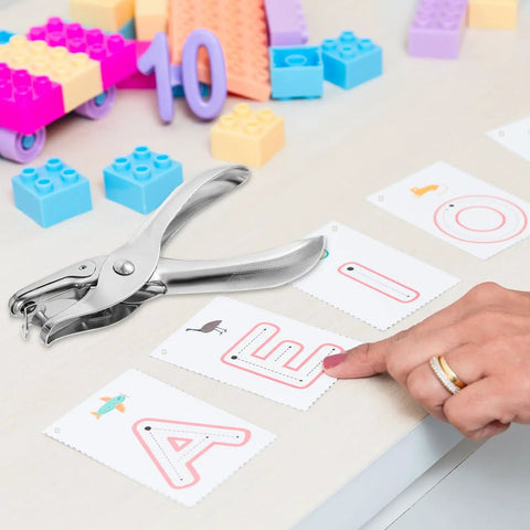 Dope 20 Pack One Quarter Inch Single Hole Punch Set, Metal Hand Paper Puncher on a desk with alphabet cards and colorful blocks