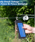 Pro Grade High Voltage Fence Tester For Farms, 12 KV Max, Portable Fault Finder With 8 Neon Indicator Lights, Electric Fence Testing Tool For Energizers, Grounds And Fence Components, Quick Readouts For Safe Accurate Fence Status. Handheld tester on fence line.