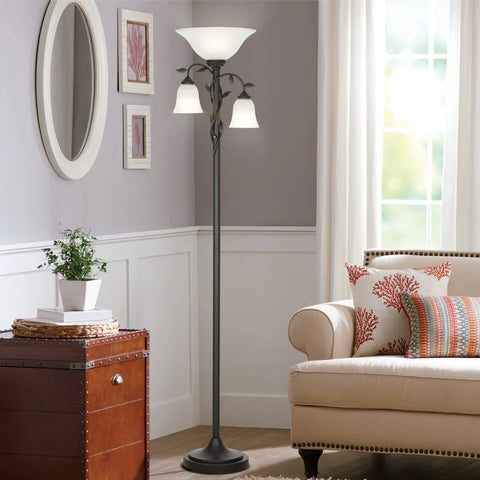 Traditional Torchiere Floor Lamp With Two Reading Lights, 72 Inches Tall, Oil Rubbed Bronze Finish, Rustic Leaf Accents And Frosted Glass Shades in a cozy living room.