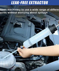 Top Shelf Vacuum Fluid Extractor Syringe Oil Pump With Extended Reinforced Hose in use for clean oil extraction.