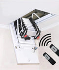 Motorized Electric Attic Ladder With Remote Control Pull Down Stairs, Heavy Duty Carbon Steel Folding Loft Access, No Sweat Setup That Is Super Convenient For Seniors And Fast Home Fixes, 70X120CM with remote controls visible.