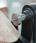 Rugged As A Nail Heavy Duty Steel Wood Lathe Faceplate Three Inches Diameter mounted to wood block for shaping projects.