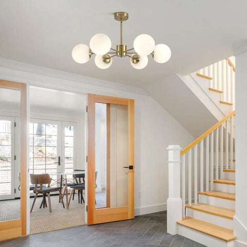 Gold Sputnik Chandelier With Six Milk Glass Globes Brass Flush Mount Ceiling Light in a modern entryway