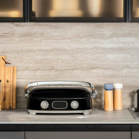 SMEG MGF01 Retro Countertop Electric Grill and Panini Press With Swappable Plates on kitchen counter with wooden boards.