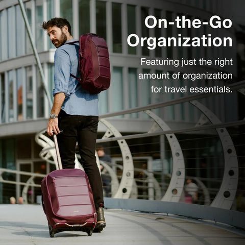 Osprey Ozone 2-Wheel carry-on luggage in burgundy; rolling suitcase with oversized wheels beside a burgundy backpack.