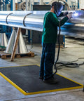 Welder using Diamond Flex Fire Retardant Rubber Anti Fatigue Mat For Welding Workstations Heavy Duty 40 By 64 Inch Industrial Floor Mat