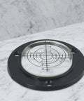 50Mm Circular Level Vial, Black For Acrylic Bubble Indicator on a marble surface with a measuring grid.