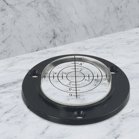 50Mm Circular Level Vial, Black For Acrylic Bubble Indicator on a marble surface with a measuring grid.