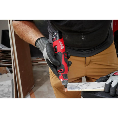Pro Grade M12 Cordless Brushless Rotary Tool With Snappy Variable Speed Dial And 12 Precision Settings delivering cuts on marble tile.