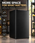 Kickin Compact 3.2 Cubic Foot Upright Freezer Solid Black Design in garage setting, showcasing extra storage features.