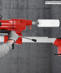 Workhorse Diamond Core Drill Machine With Heavy Stand, 4250W 500RPM Copper Motor Built For Wet Concrete And Masonry Coring, Dead Simple Depth Control And Safety Clutch, 10 Inch Bit in use on a concrete wall.