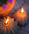 Golden Barrel Cactus Torch Outdoor Yard Art In Weatherproof Steel Large 18 Inch Wide By 13 Inch High Lawn Decor That Burns For 4 To 6 Hours Southwestern Desert Tiki Light For Backyard Vibes shown burning on a stone patio.