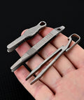 Alloy Pocket Tweezers For Camping And Hiking Gear resting on palm, compact design, rust-resistant, multipurpose splinter remover