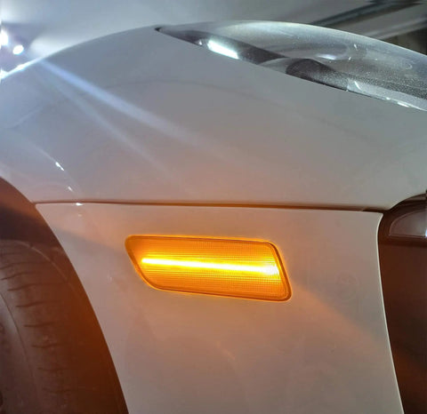 Close-up of Smoked Lens Full LED Front Side Marker Kit for Porsche Macan 2014-2024, Amber Sidemarker Lights installed, illuminated view.
