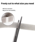 Kick Out Drafts With Premium Heavy Duty Foam Weather Stripping Tape Adhesive Door And Window Seal Half Inch Thick PU Compression Sponge Roll being cut with scissors.