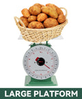 Heavy Duty Mechanical Kitchen And Food Scale With Stainless Steel Platform, showing 220lbs capacity with potatoes on it