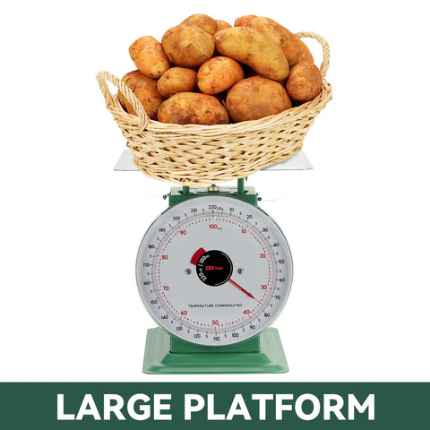 Heavy Duty Mechanical Kitchen And Food Scale With Stainless Steel Platform, showing 220lbs capacity with potatoes on it