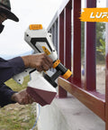 Heavy Duty 700W HVLP Electric Paint Sprayer Featuring A Roomy 1200ml Tank And Five Brass Nozzles With Three Adjustable Patterns For No Sweat Furniture Fence And Wall Finishes, in use on a red fence.