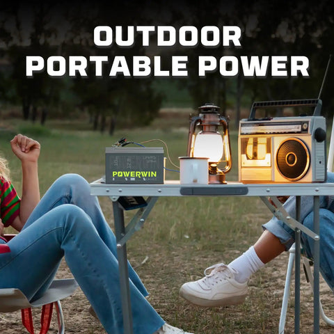 Outdoor scene with 12V LiFePO4 BT10 Battery with Built-In BMS 128Wh Portable UPS Backup on table, powering lantern and radio.