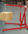 Heavy Duty Foldable Shop Crane Engine Hoist Rolling Cherry Picker With 4409 Lb Capacity hydraulic boom lifting a box in a workshop.