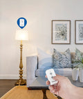 Hand holding Plug And Play Remote Outlet Switch with Wireless On Off Control for lamps in living room setting.