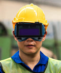 Slick Auto Darkening Welding Goggles With Flip Up Lens And Anti Scratch Shield worn by a worker in safety gear for welding.