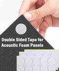 Close-up of hand holding black acoustic foam panel with double sided tape, part of Twelve Pack High Density Pyramid Acoustic Foam Wall Panels With Strong Self Adhesive Backing Sound Proof Tile Blocks Chatter Zero Echo Tight Home Recording Setup.