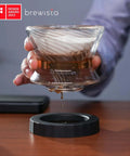 Tornado Duo Pour Over Coffee Dripper Barista Grade With Double Wall Glass Insulated Body Easy To Clean Dripper For Home Or Office 1 To 2 Cups 18 Rib Design Slows Water For Rich Flavor And Smooth Extraction in use, showing double-walled glass and coffee dripping.